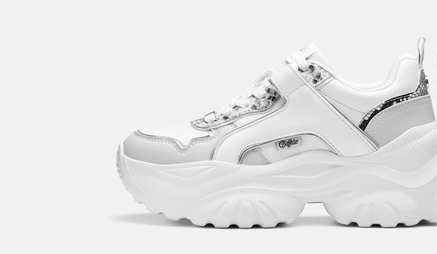 Side view of a white chunky Buffalo sneaker with textured sole and lace-up design on a light background