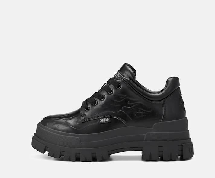 Black Buffalo lace-up shoe with chunky lug sole and subtle flame detailing on a light grey background.