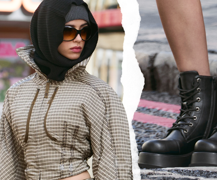 Person wearing a checked jacket and black platform lace-up boots