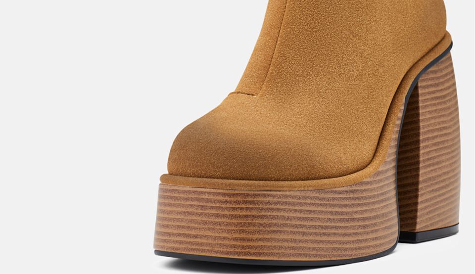 Close-up of tan BUFFALO platform ankle boot with wooden-look heel.