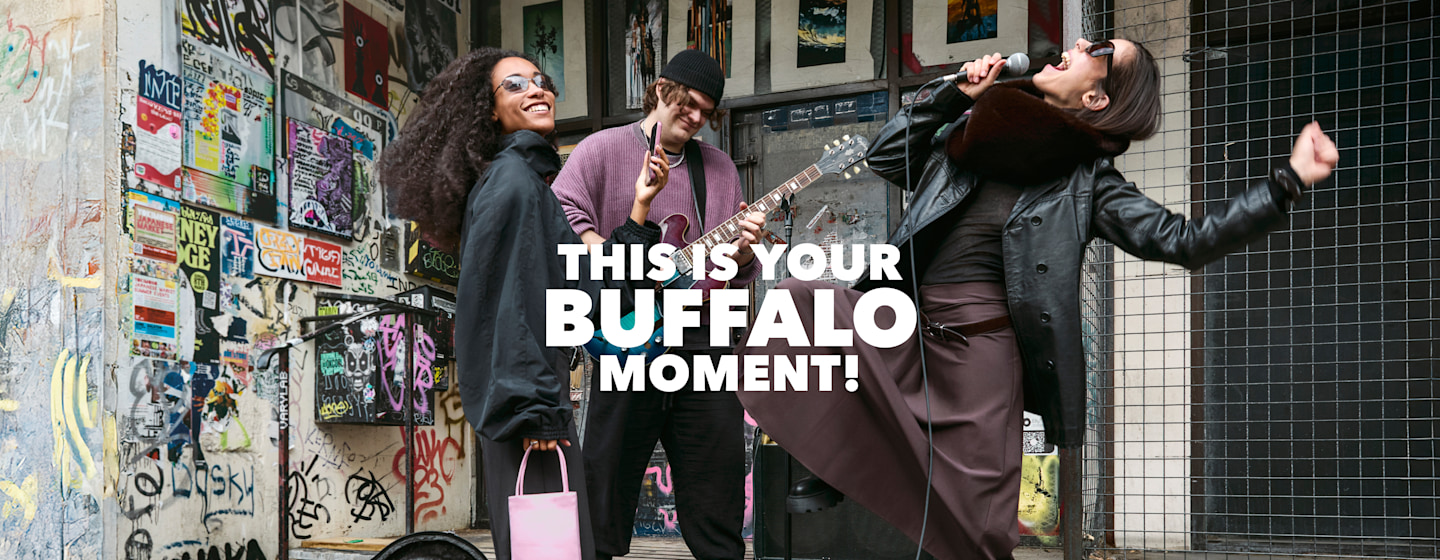 Three people in an urban street scene with “This Is Your Buffalo Moment” campaign text