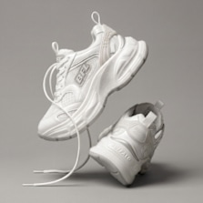 White chunky sneakers shown in a floating product shot against a neutral background.